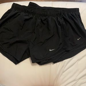 2 black lined Nike shorts